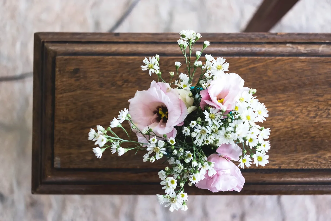 Flowers resting on a polished casket